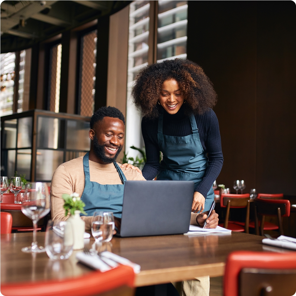 Two people working on a computer.
