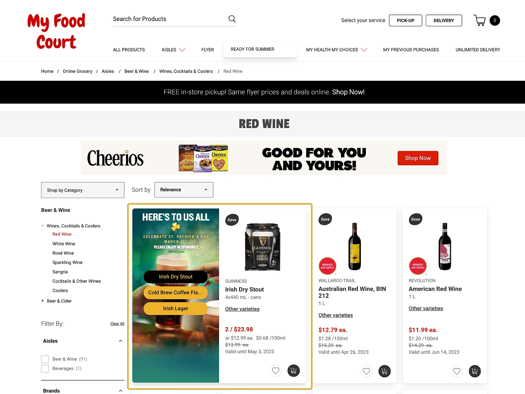 Screenshot of the My Food Court online grocery website showing a Red Wine category page with a sponsored Cheerios banner ad at the top, followed by product listings including Irish Dry Stout, Australian Red Wine BIN 212, and American Red Wine, each with prices and promotional badges.