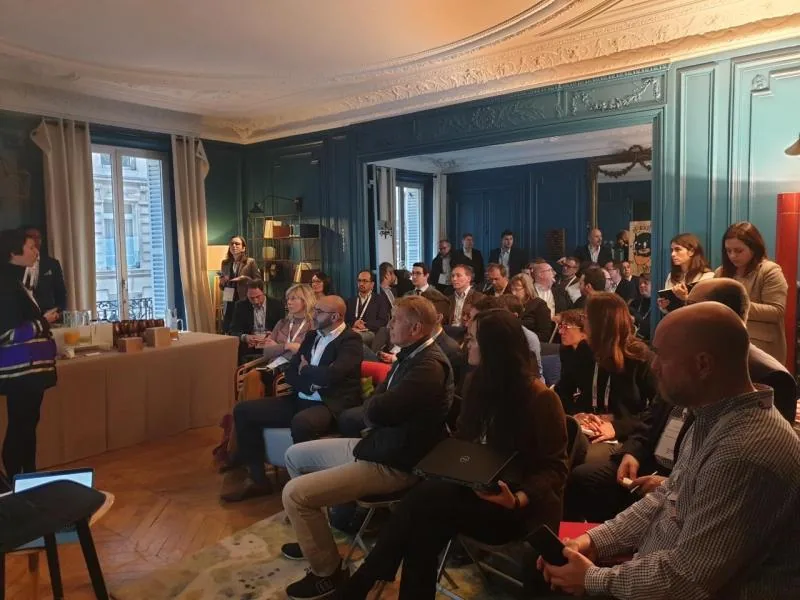 Group photo of attendees at the B2B Platforms Masterclass event in Paris, seated and standing in a conference room setting
